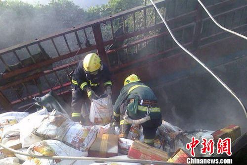8月1日6時(shí)左右，滬昆高速上饒段一貨車側(cè)翻著火，駕駛室燒成空殼。圖為消防官兵清理現(xiàn)場。吳兵章 攝